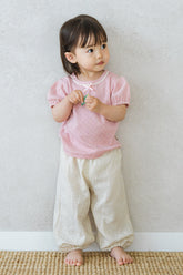 Toddler Sitting Comfortably in Avauma Merry Purp Cotton Pink Top, Soft Kids Clothing